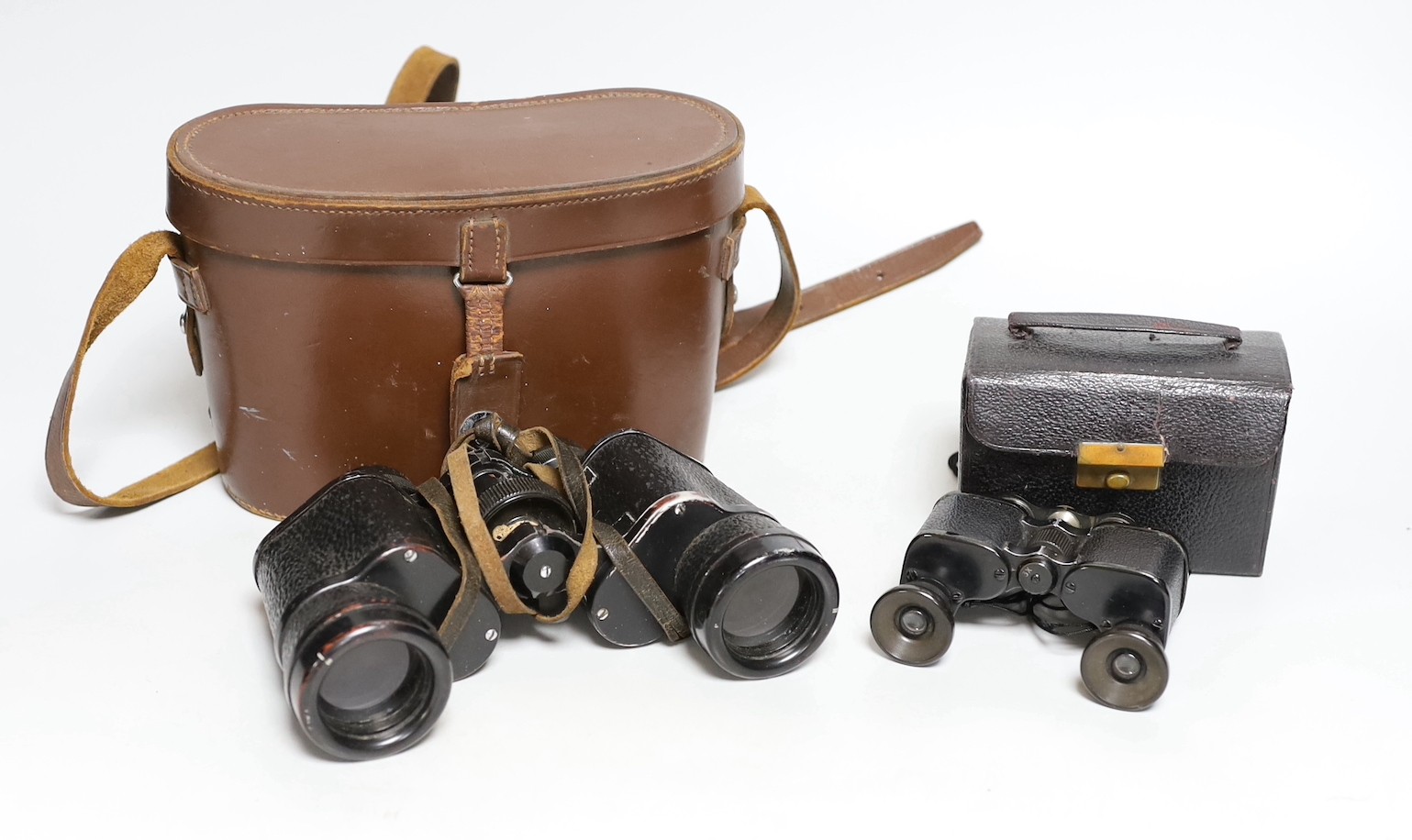 A cased set of Ross binoculars and a smaller cased set for racing